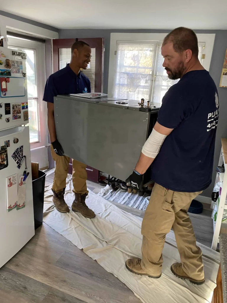 PlumbPRO Services technicians with air handler